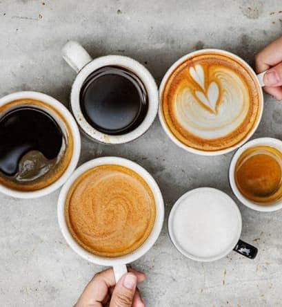 a group of coffees and coffee cups on a table at Hampton in Highland Apartments, Highland, IN