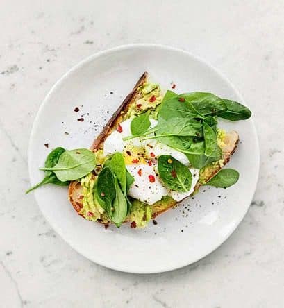 a piece of toast with egg and spinach on a white plate at Hampton in Highland Apartments, Highland, 46322