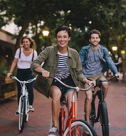 a group of people riding bikes down a street