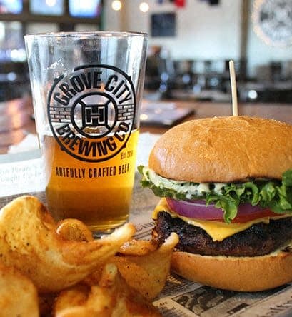 a burger and fries and a glass of beer