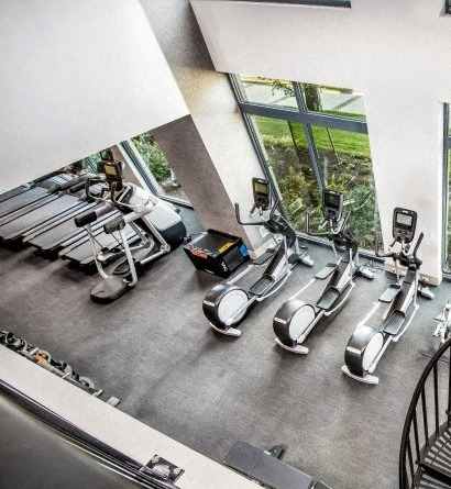 A gym with treadmills and elliptical machines.