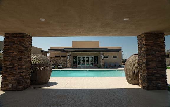 A modern house with a pool in the backyard.