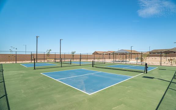 A tennis court with a blue surface and white lines.