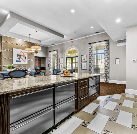 a kitchen with granite countertops and stainless steel appliances