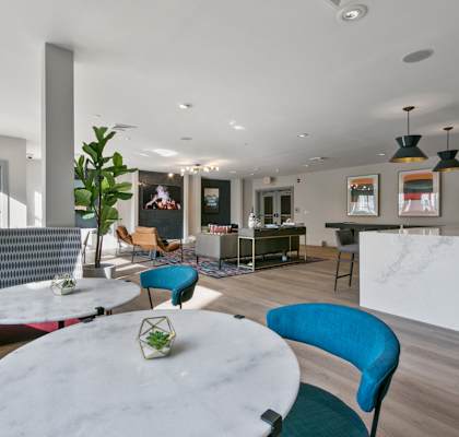 a living room with blue chairs and a white table