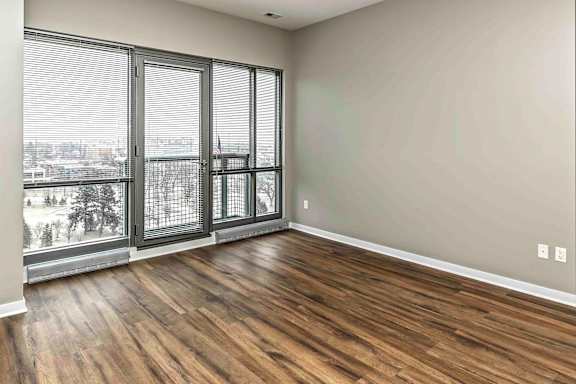 Wood flooring and 10 to 12 foot windows in living room at Midtown Crossing