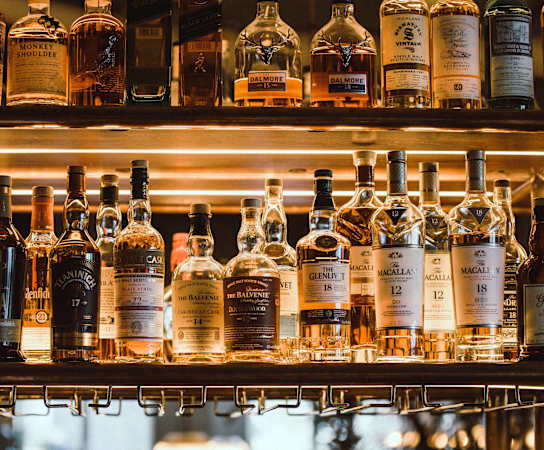 A shelf of liquor bottles in a bar at Silverbrook Apartments Apartments, Ridgeland, MT, 59901