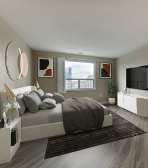 a bedroom with a bed and a tv in a 555 waverly unit