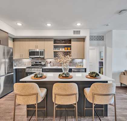 A modern kitchen with a dining table and chairs.