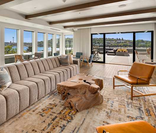 a large living room with a large couch and a table at Liza Apartments, Washington
