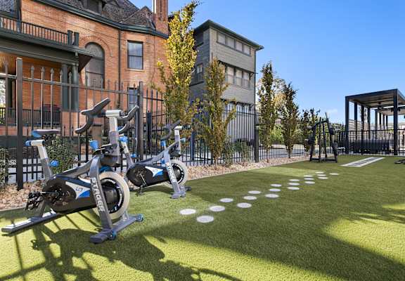 a group of exercise bikes parked outside of a building