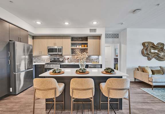 A modern kitchen with a dining table and chairs.