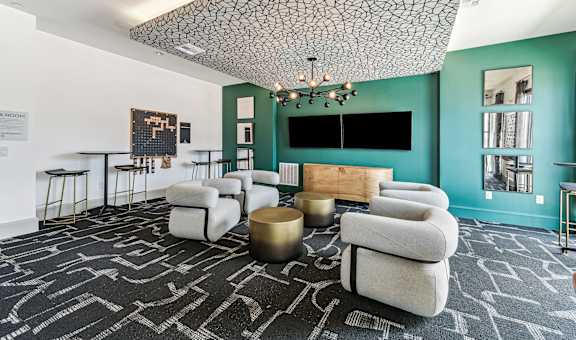 a living room with couches and chairs and a tv