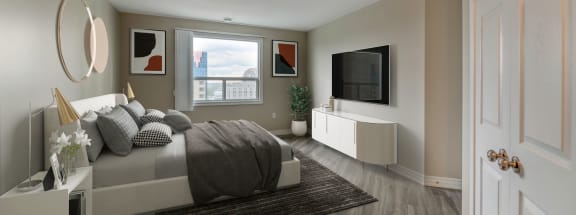 a bedroom with a bed and a tv in a 555 waverly unit