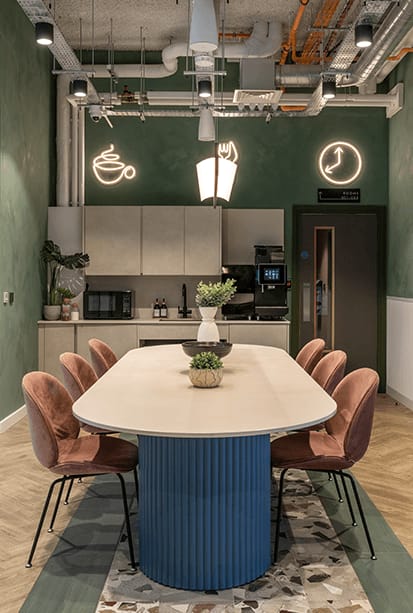a dining room with a long white table and chairs