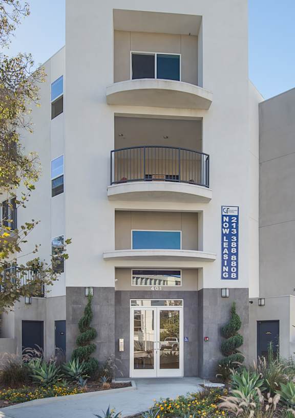 A modern building with a balcony on the second floor.