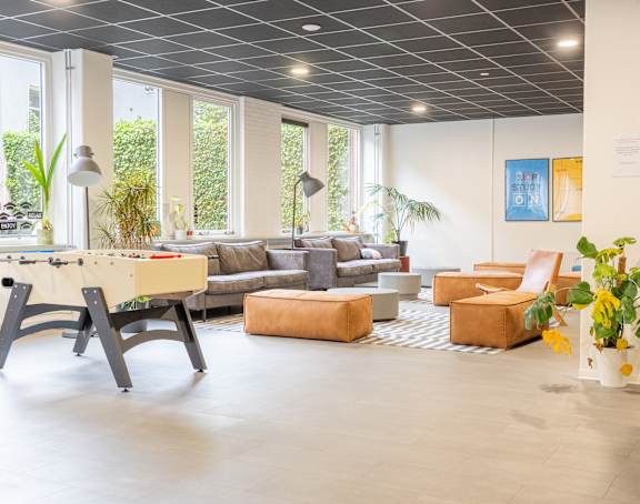A modern living room with a dining table and chairs.
