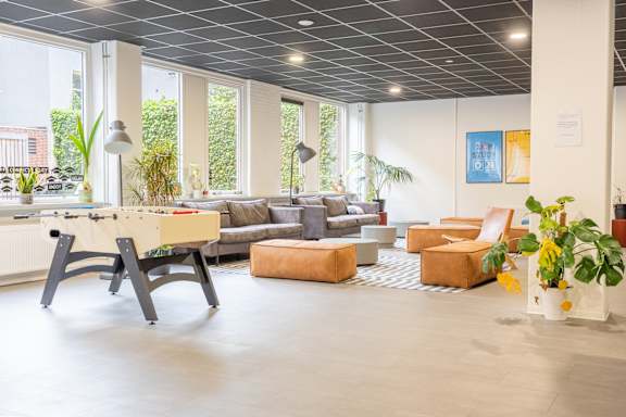 A modern living room with a dining table and chairs.
