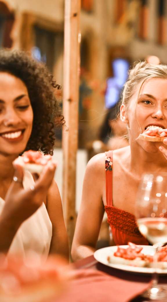 Two women enjoying a meal together at a restaurant.