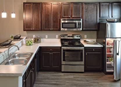 a kitchen with a stove a sink and a refrigerator