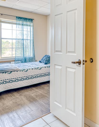 a bathroom with a shower and a bed