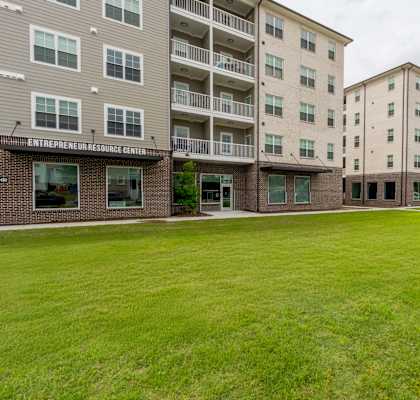 A grassy area in front of a building with the words Entrepreneur Resource Center on it.