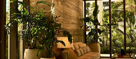 A large, well-lit lobby with a checkered floor and a large hanging light fixture.