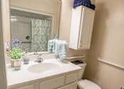 Thumbnail 20 of 31 - A bathroom with a white sink and toilet.