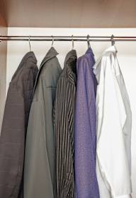 A row of jackets hanging on a rack.