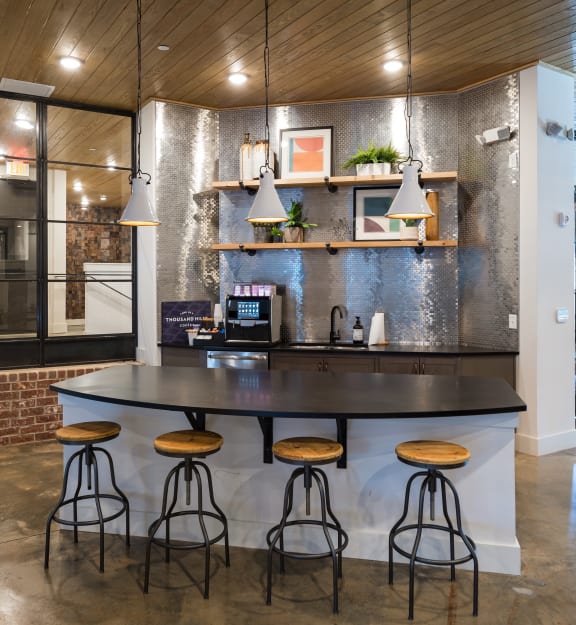 a kitchen with a large island and bar stools
