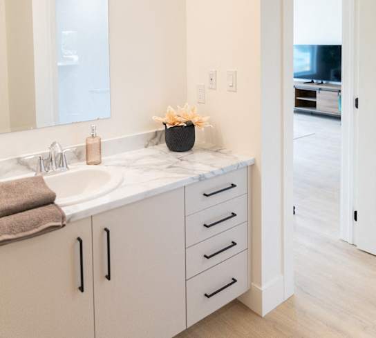 a white bathroom with a sink and a mirror