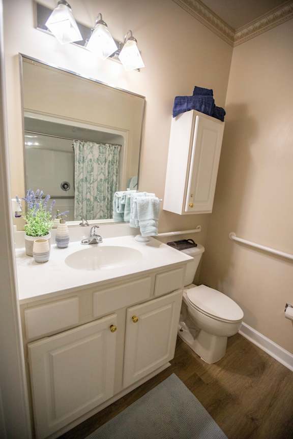 A bathroom with a white sink and toilet.