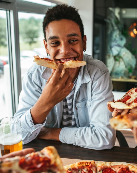 a man and a woman eating pizza at a restaurant at Mill Pond Apartments, Washington