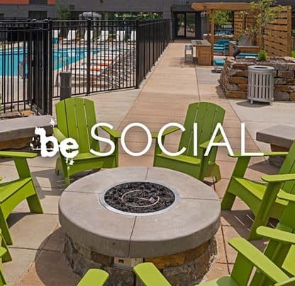 Be Social phrase with background of outdoor fire pit with green chairs around fire pit at Be @ Axon Green, Minneapolis, MN