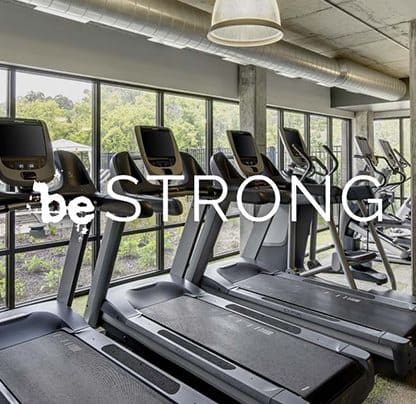 Be STRONG phrase with treadmills in background facing windows at Be @ Axon Green, Minneapolis, MN