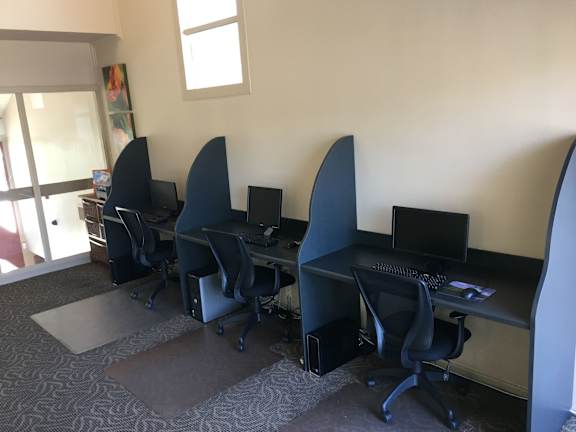 Computer workstations with black chairs.