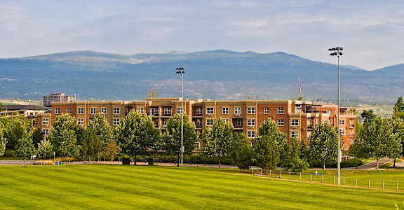 A large building with a green lawn in front of it.