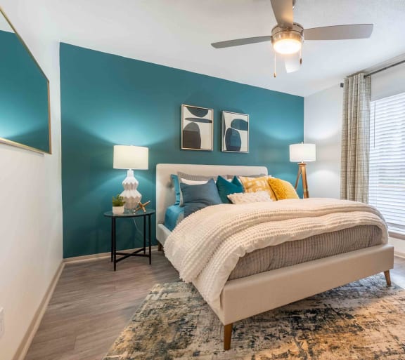 a bedroom with a bed and a ceiling fan