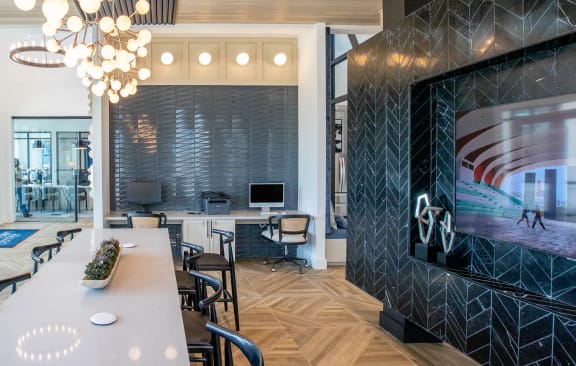 a conference room with a long table and chairs and a large tv on the wall