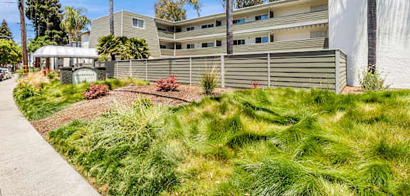 A modern building with a green lawn in front.