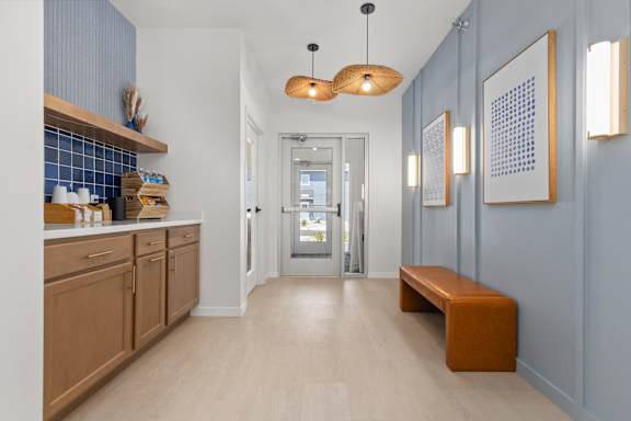 A hallway with a bench and pictures on the wall.