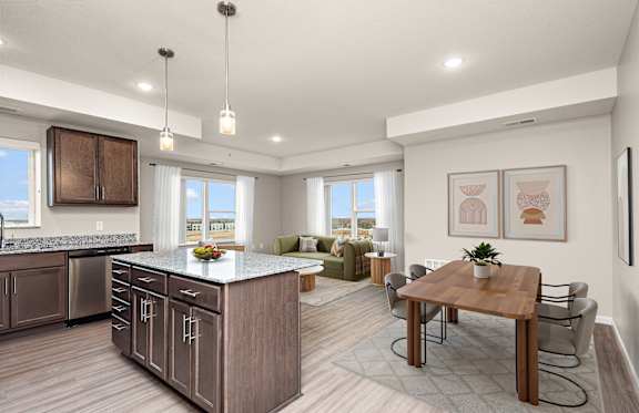 A modern kitchen with a dining table and chairs.