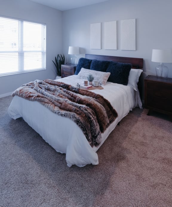 a bedroom with a bed and a picture on the wall