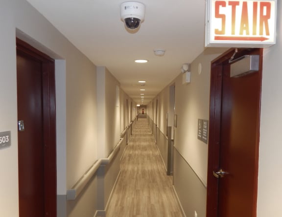 a long hallway with doors and a star sign on the side