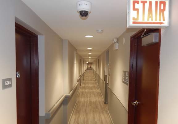 a long hallway with doors and a star sign on the side