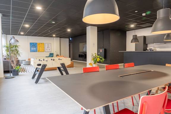 A modern dining area with a long table and chairs.