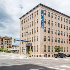 a large brick building at the corner of a street