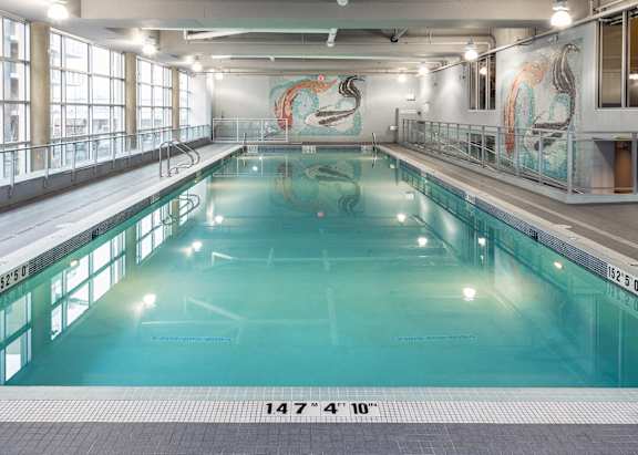 A large indoor swimming pool with a length of 147 feet and 4 inches.