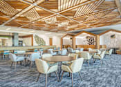 Thumbnail 10 of 24 - A modern dining room with a wooden ceiling and grey carpet.