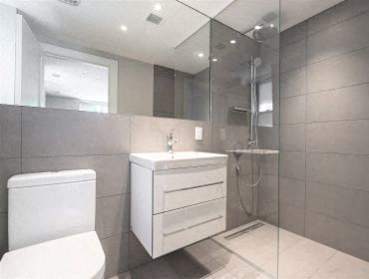 a bathroom with a toilet and a sink and a shower